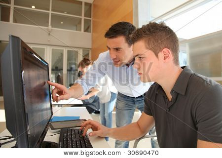Picture or Photo of Teacher and student working on computer