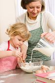 pic of family  - Grandmother and granddaughter baking cookies prepare dough - JPG 