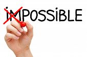 stock photo of possibility  - Hand turning the word Impossible into Possible with red marker isolated on white - JPG 