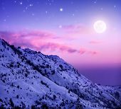 pic of holidays  - Photo of beautiful snowy mountains on purple sunset background - JPG 