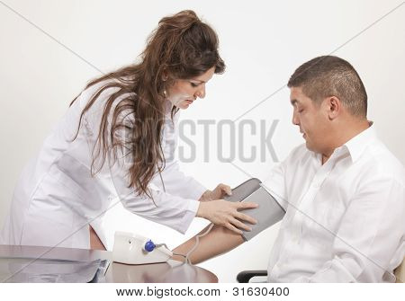 Picture or Photo of Doctor measuring blood pressure - studio shot