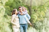 image of family  - Young happy family of three having fun together outdoor - JPG 