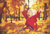Happy Little Child, Baby Girl Laughing And Playing In Autumn