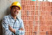 foto of construction  - Happy male construction worker wearing a helmet and smiling - JPG 