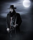 foto of stay  - Handsome man in cowboy costume stay in steppe at night with full moon - JPG 
