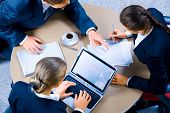 stock photo of meeting  - Image of three business people working at meeting - JPG 