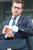 picture of watch  - Businessman checking time on his watch - JPG 
