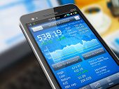 picture of money  - Macro view of stock market application on touchscreen smartphone - JPG 