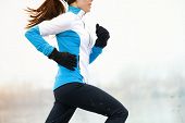 foto of fitness  - Running athlete woman sprinting during winter training outside in cold snow weather - JPG 