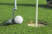 pic of lag  - putter puts a golf ball to hole on green of golf course - JPG 