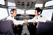 pic of handshake  - Happy pilots handshaking in the airplane cabin - JPG 