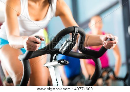 Picture or Photo of Young People - group of women and men - doing sport Spinning in the gym for fitness