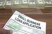 picture of bill  - Approved small business loan application and dollar bills - JPG 