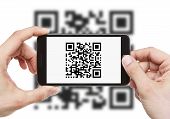 stock photo of code  - Male hands holding smart phone with qr code on it - JPG 