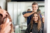 stock photo of setting  - Happy hairstylist setting up client - JPG 