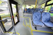 picture of seating  - Seats in passenger compartment of empty city bus with big windows - JPG 