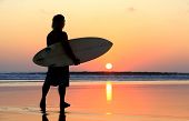 stock photo of sunset  - Silhouette of surfer at red sunset - JPG 