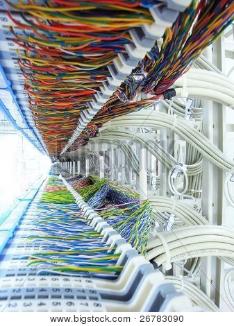 Picture or Photo of A shot of network cables and servers in a technology data center
