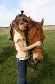 foto of quarter horse  - A girl on a spring day on a Texas ranch during a peaceful moment with her horse - JPG 