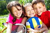 stock photo of sports  - Three children with sports equipment embracing - JPG 