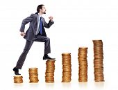 stock photo of businessmen  - Businessman climbing gold coins stacks - JPG 