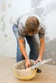 stock photo of construction worker  - Plasterer at work doing indoor house repair with plaster - JPG 
