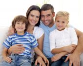 foto of family  - Happy young family sitting on sofa at home - JPG 