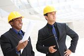 foto of construction worker  - An attractive business team working construction on the building site - JPG 