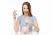 foto of money  - Woman putting money in piggy bank - JPG 