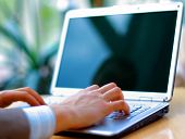stock photo of laptop  - Person Typing on a modern laptop in an office - JPG 