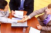 picture of handshake  - business handshake over workplace - JPG 