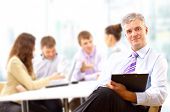 foto of meeting  - Portrait of a senior business man attending a conference with the rest of his business team - JPG 