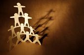 picture of leadership  - Human team pyramid on brown background - JPG 