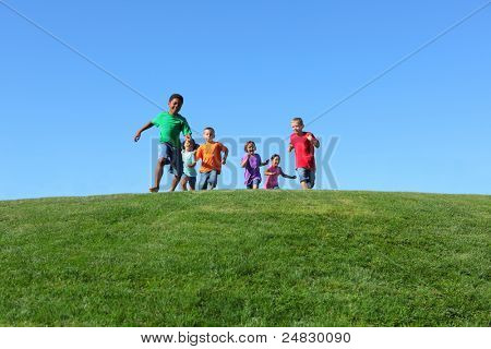 Picture or Photo of Group of kids running on grass hill with blue sky