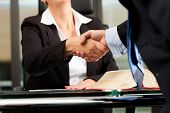stock photo of meeting  - Mature female lawyer or notary with client in her office  - JPG 