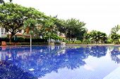stock photo of blue sky  - A clubhouse with swimming pool with blue water - JPG 