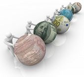 stock photo of currency  - Several figures pushing balls marked with world currencies push forward in a race for growth - JPG 