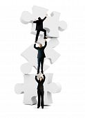 pic of business people  - Group of business people climbing on the pieces of a puzzle  - JPG 