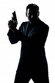 stock photo of bond  - one caucasian spy criminal policeman detective man holding gun portrait silhouette in studio isolated white background - JPG 