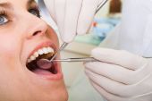 stock photo of watch  - Female patient receiving professional dental operation from dentist - JPG 