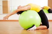 stock photo of fitness  - Woman doing fitness in a gym on a ball - JPG 
