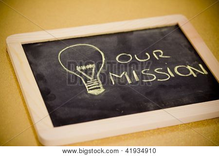 Picture or Photo of Lighbulb and business mission chalk design on blackboard