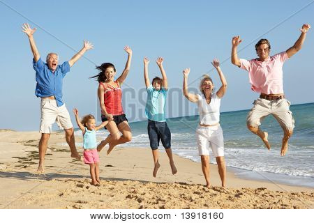 Picture or Photo of Portrait Of Three Generation Family On Beach Holiday Jumping In Air