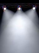 stock photo of spotlight  - A Stage Light Rack with 3 Spotlights Shining down towards the middle of the layout in a dark area - JPG 