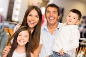 picture of family  - Portrait of happy family in a clothing store smiling - JPG 
