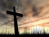 image of nature  - Concept conceptual black cross or religion symbol silhouette in grass over a sunset or sunrise sky with sunlight clouds background - JPG 