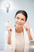 foto of money  - happy woman with cash euro money and light bulb - JPG 