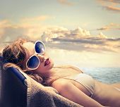 foto of beach  - blonde woman in bikini sunbathing on the beach - JPG 