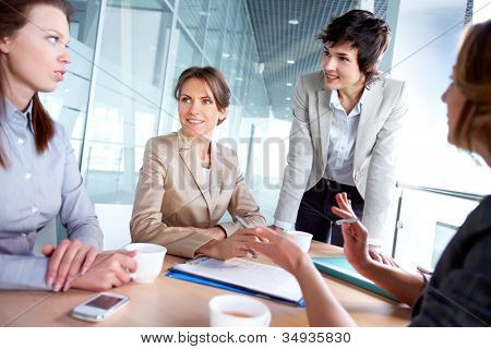 Picture or Photo of Female business team of four working together to achieve good results