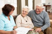 picture of home  - Senior Couple In Discussion With Health Visitor At Home - JPG 